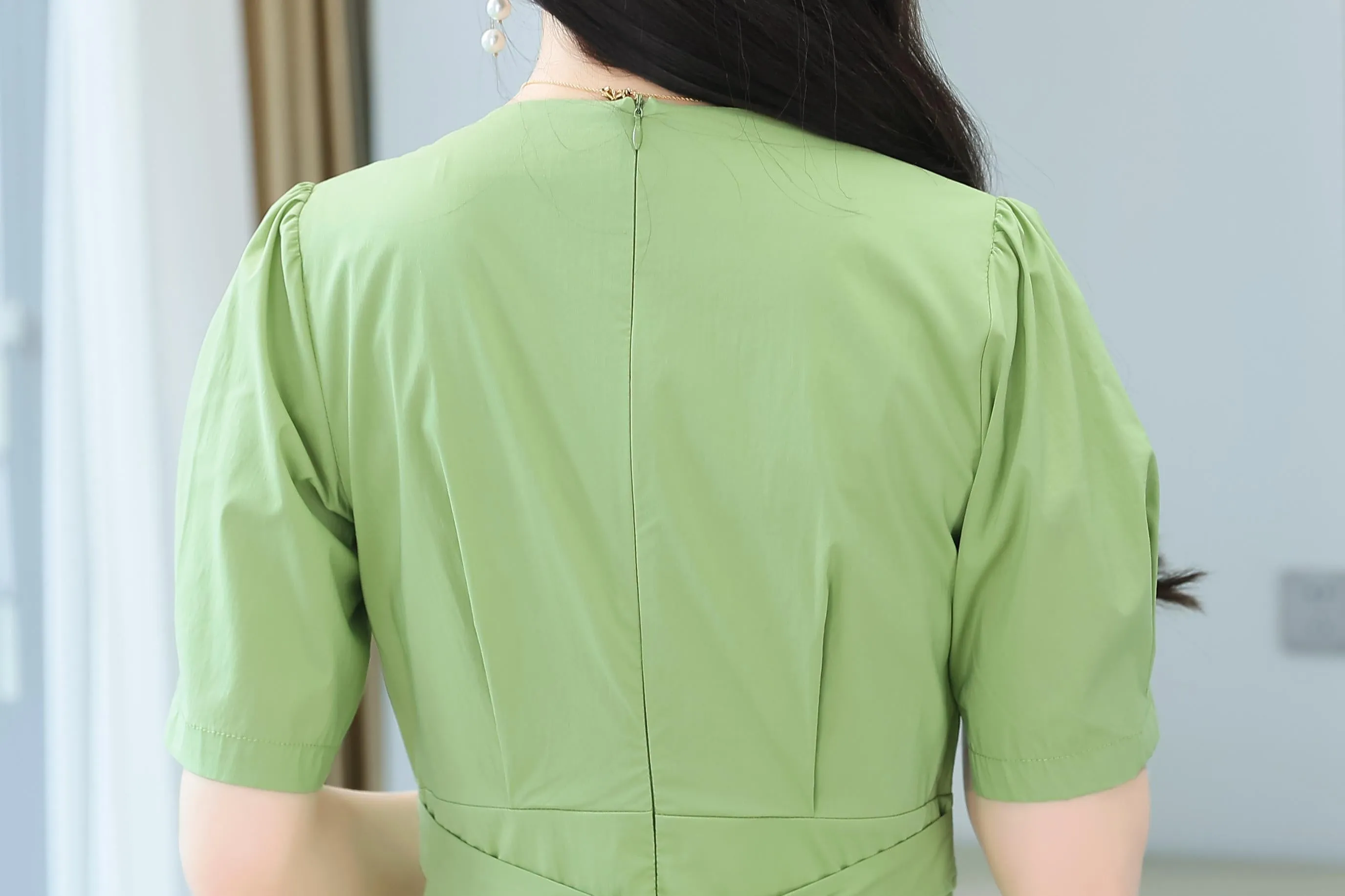Sweet French-style dress featuring button decoration and a fitted waist