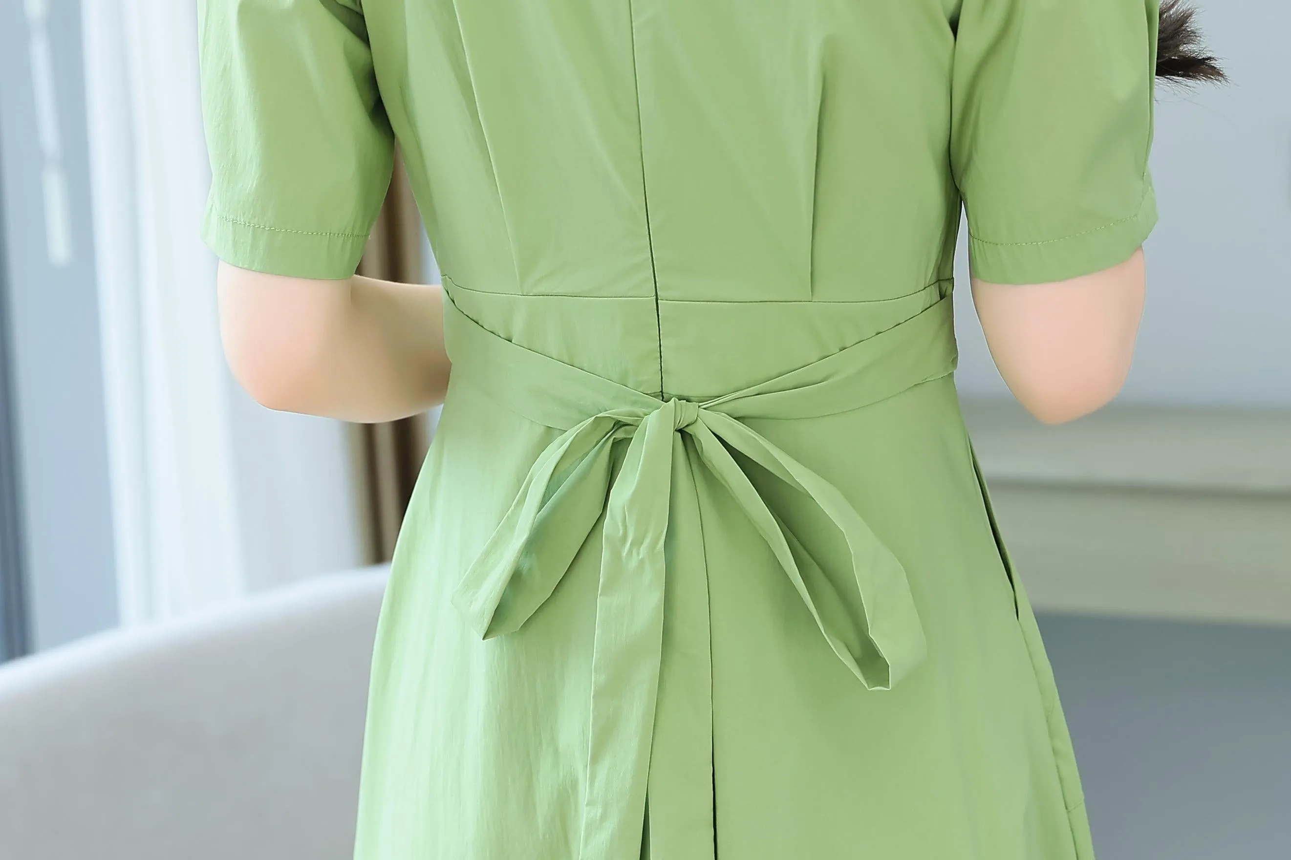 Sweet French-style dress featuring button decoration and a fitted waist