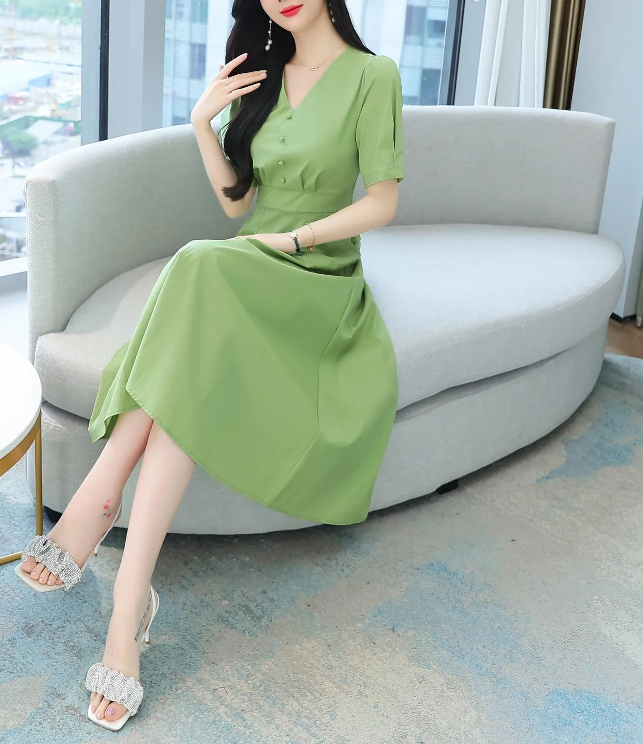 Sweet French-style dress featuring button decoration and a fitted waist