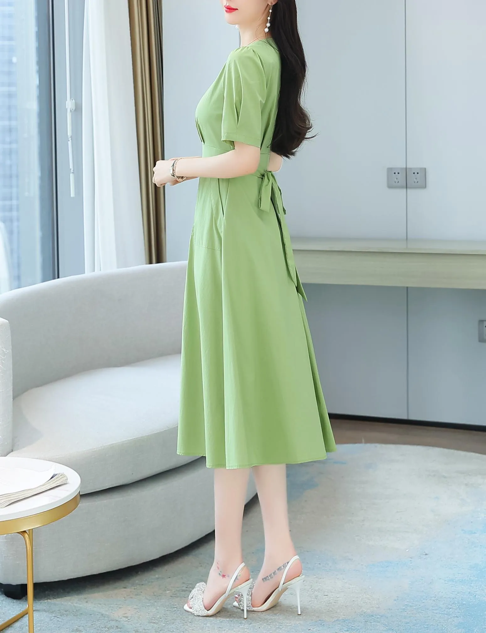 Sweet French-style dress featuring button decoration and a fitted waist