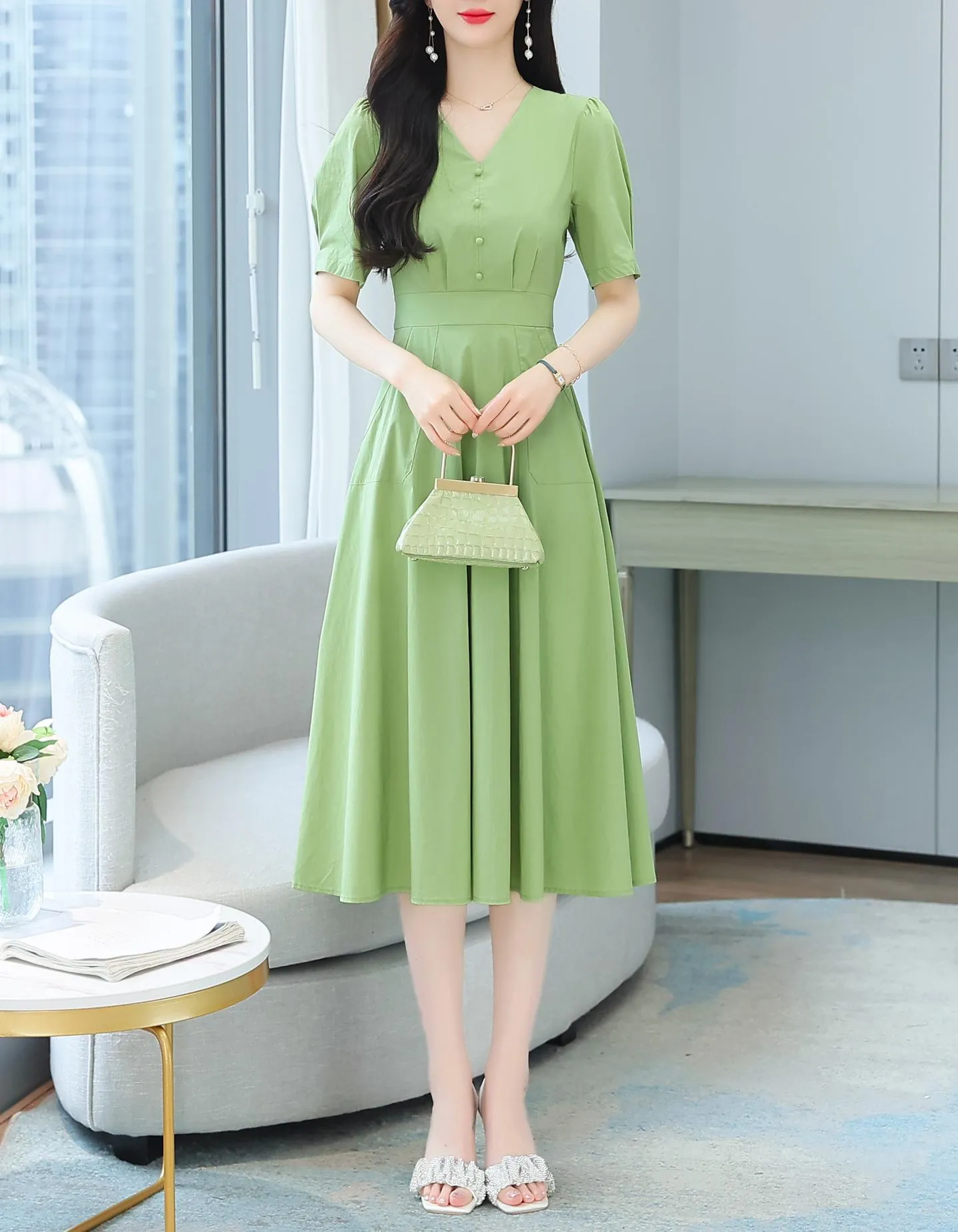 Sweet French-style dress featuring button decoration and a fitted waist