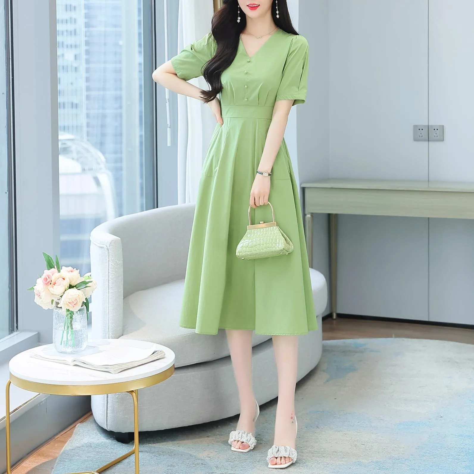Sweet French-style dress featuring button decoration and a fitted waist