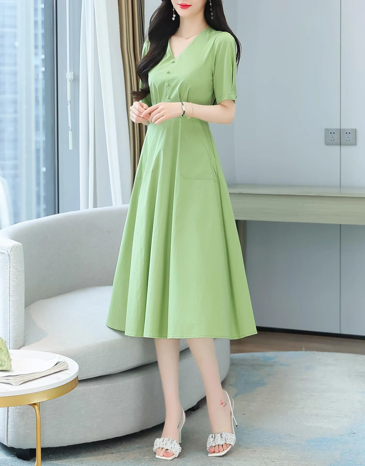 Sweet French-style dress featuring button decoration and a fitted waist