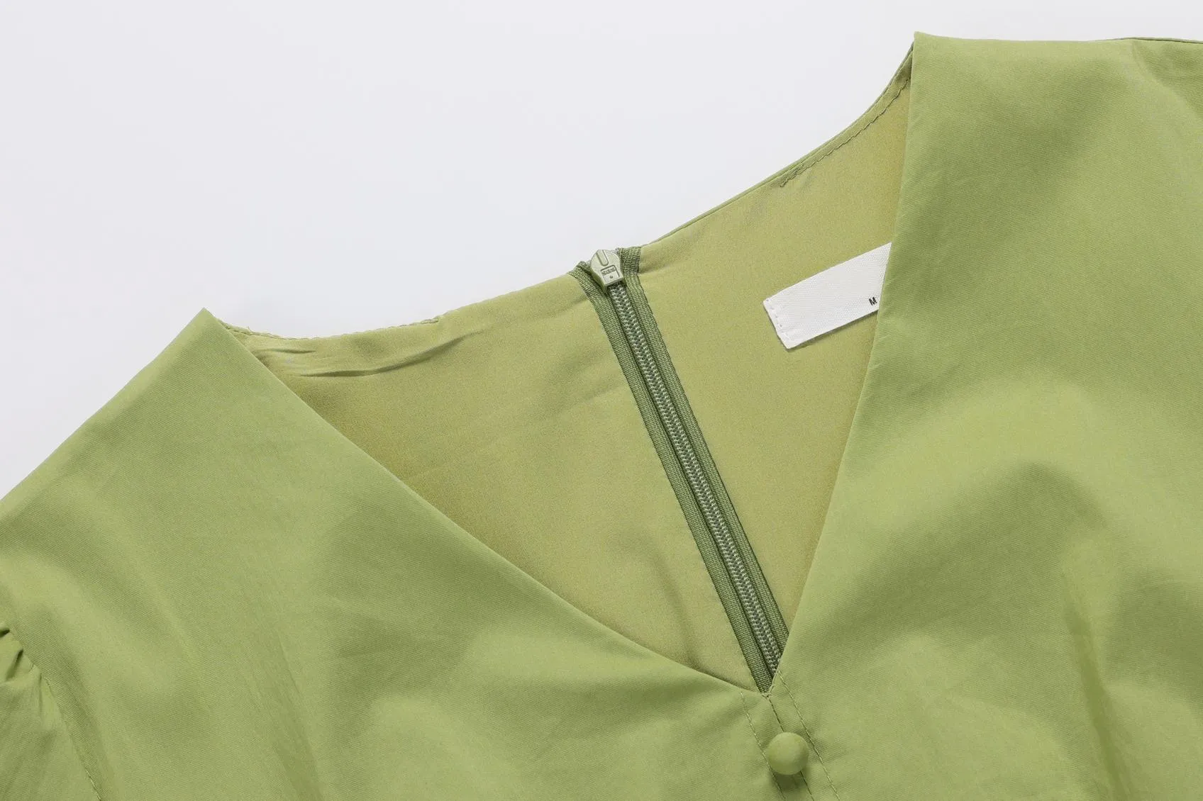 Sweet French-style dress featuring button decoration and a fitted waist