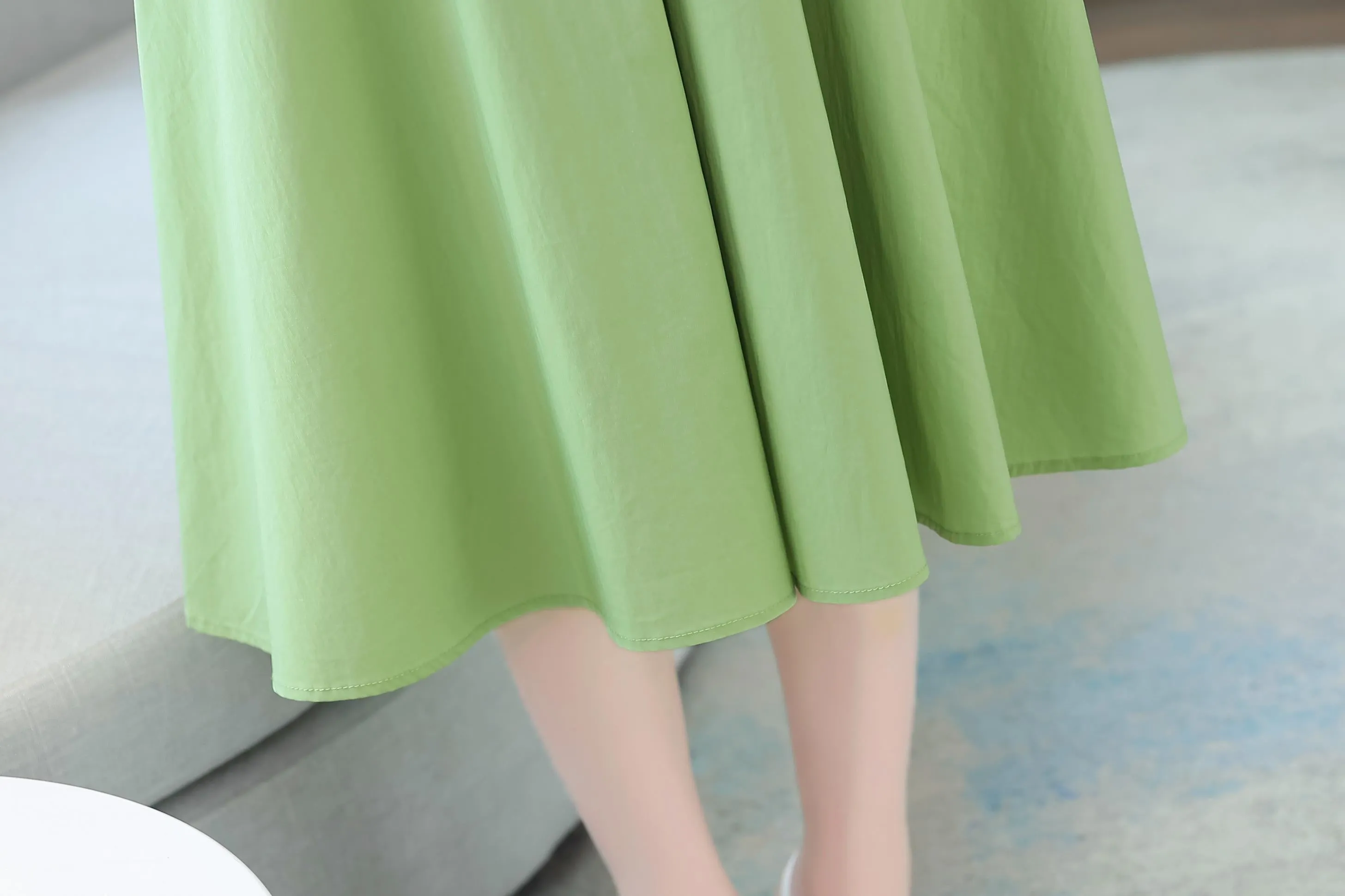 Sweet French-style dress featuring button decoration and a fitted waist