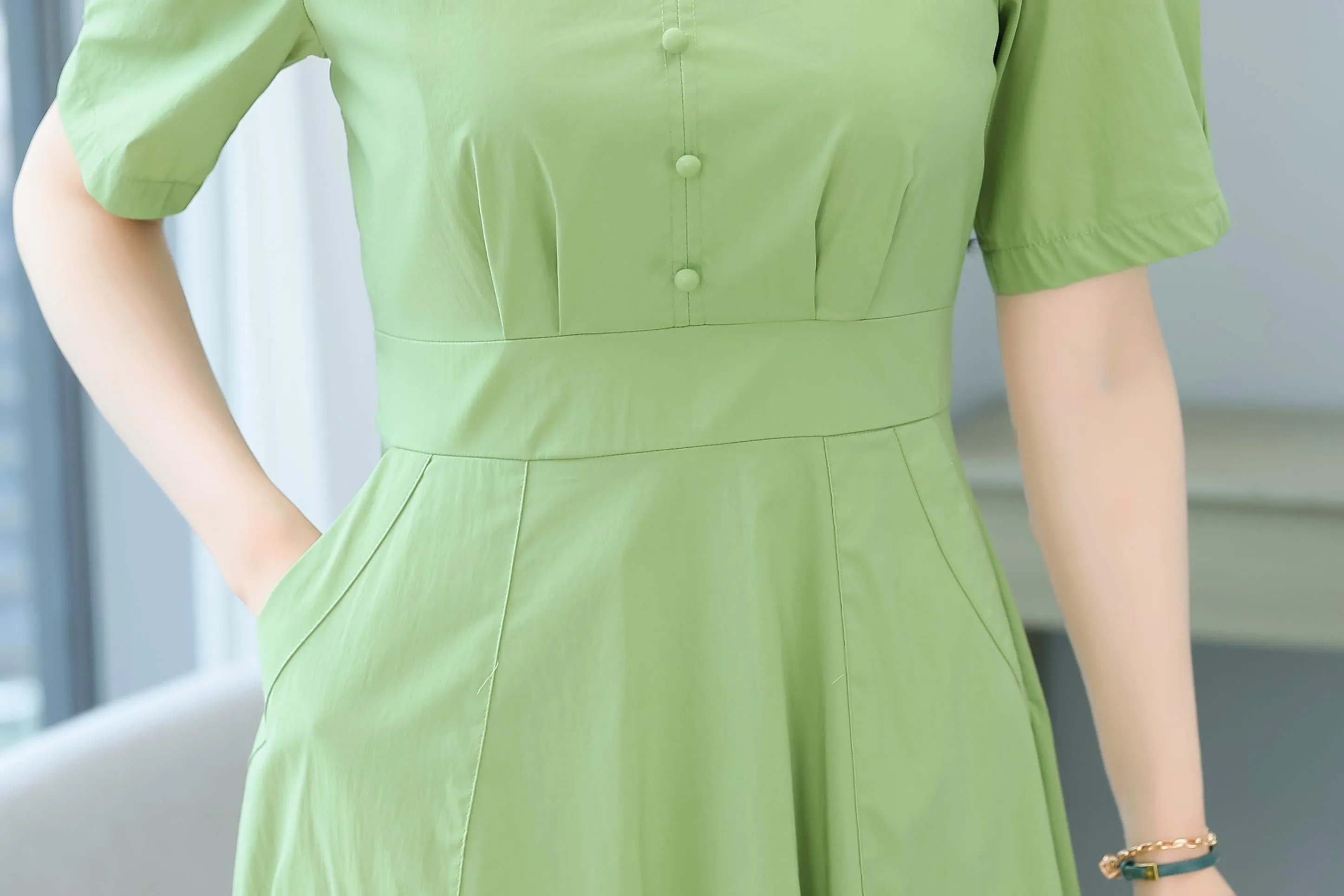 Sweet French-style dress featuring button decoration and a fitted waist