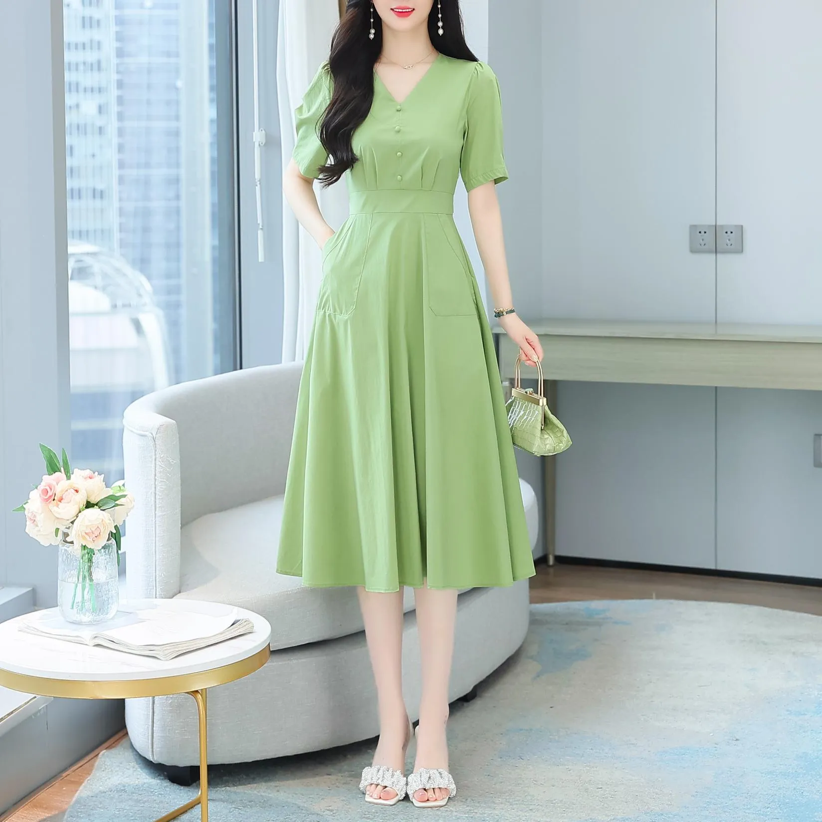 Sweet French-style dress featuring button decoration and a fitted waist
