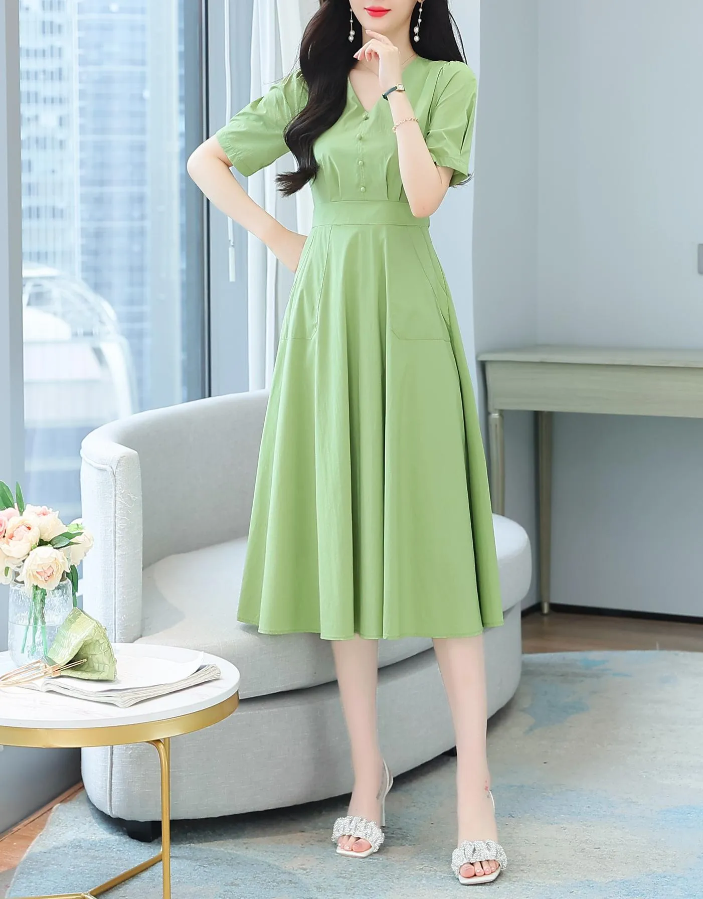 Sweet French-style dress featuring button decoration and a fitted waist